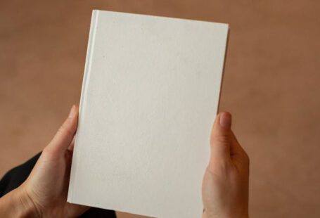 Meet New People - Person holding hardcover book with blank cover