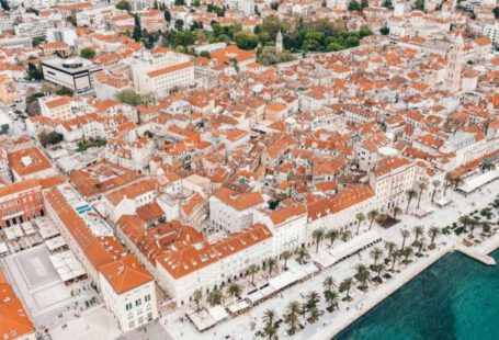 Split Travel Costs - Coastal town embankment with red roofed buildings