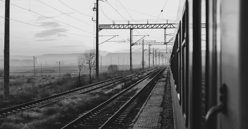 Transportation Options - Black and white photo of train tracks and wires