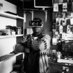 Local Experiences - Black man in VR goggles in electronics store