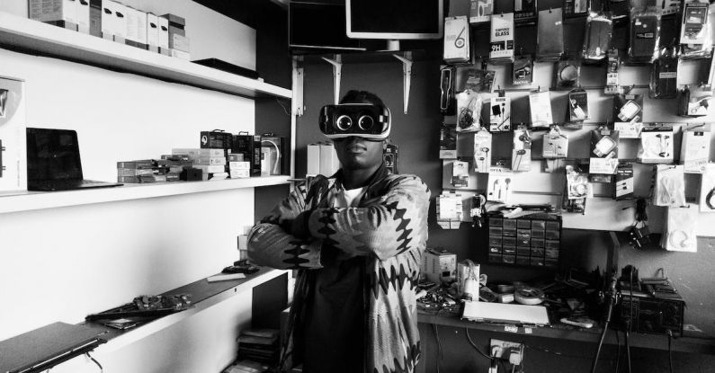 Local Experiences - Black man in VR goggles in electronics store